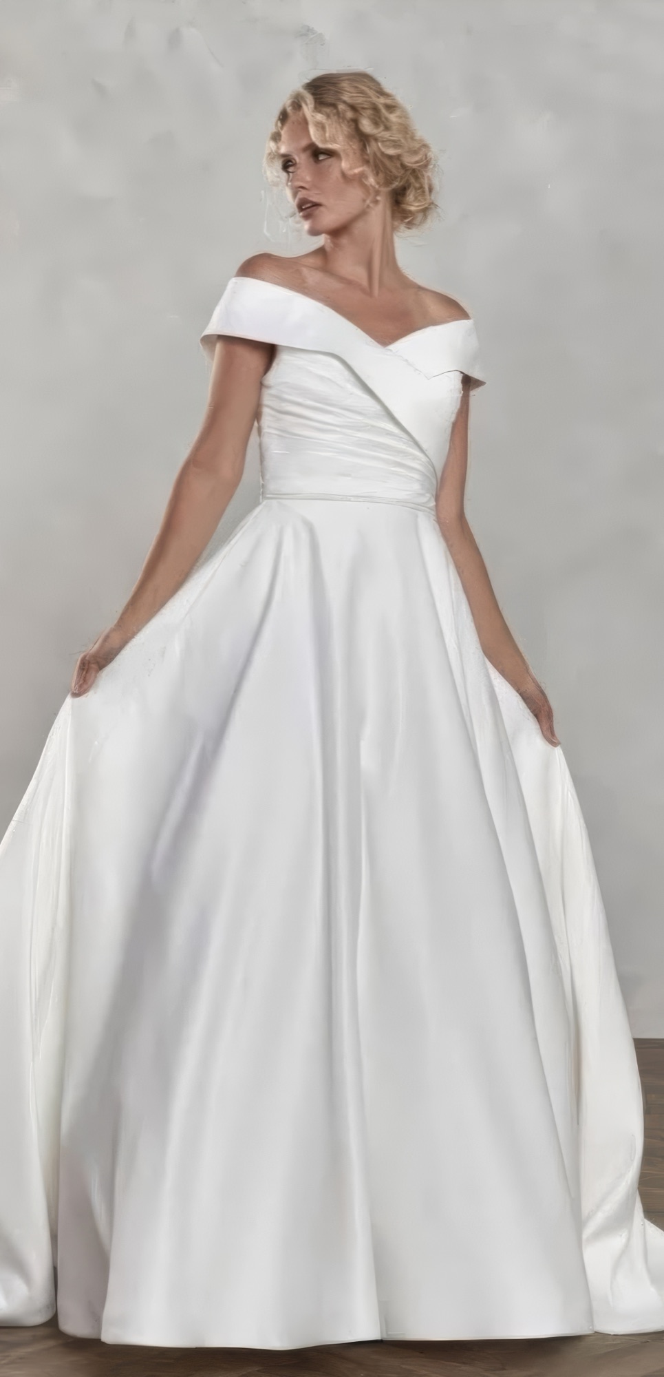 A bride in an off-shoulder satin ballgown